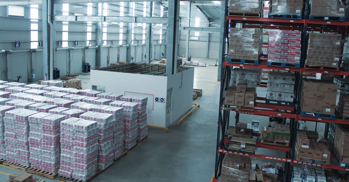 Forklift lifting pallets in a high-bay racking aisle
